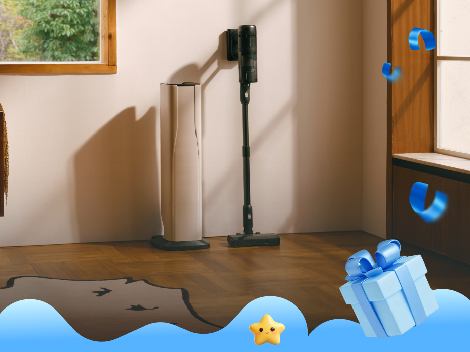 Black Roborock H60 Hub Ultra cordless stick vacuum leaning against a white wall next to its docking station on a wooden floor
