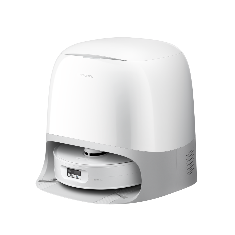 Roborock Qrevo Curv 2 Flow robot vacuum in white shown from above with its curved charging and washing dock in the background, displaying the SpiraFlow roller mop extending beneath the robot body