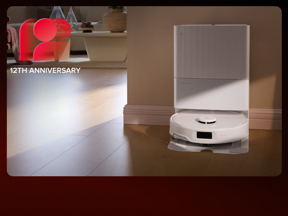 Black Roborock Qrevo S5V robot vacuum docked in a tall black base station on a wooden floor in a living room setting