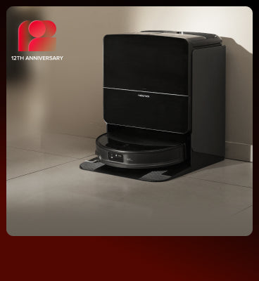 Black Roborock Saros 10R robot vacuum docked in a black base station on a light-colored floor
